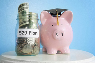 Piggy bank next to jar of money labeled 529 plan