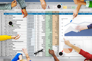 Spreadsheet overlaid with coffee cups and employees' hands pointing to pieces of data