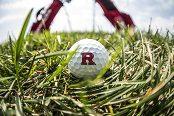 Golf ball with Rutgers 'R' logo on turfgrass