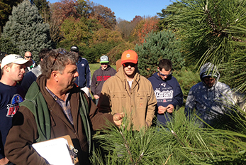 Instructor Steve Kristoph teaches a hands on plant identification session in the Rutgers Gardens