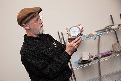 Radon Mitigation instructor Bill Brodhead holds up a meter