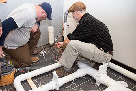 Bill Brodhead works with a student during the hands-on portion of the Radon Mitigation course